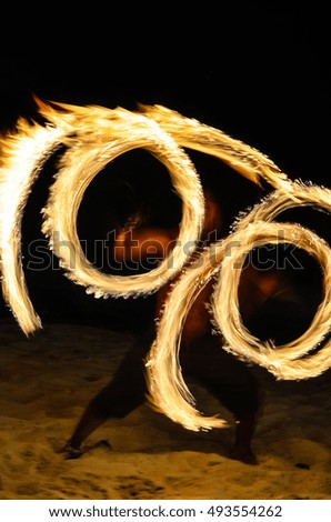 Fire show on the beach. Holiday travelers. Slow shutter speed. Night Scene
