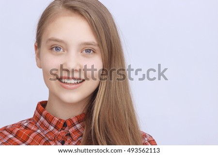 portrait of smiling teenage girl in shirt