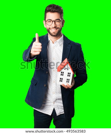 young man holding a house object