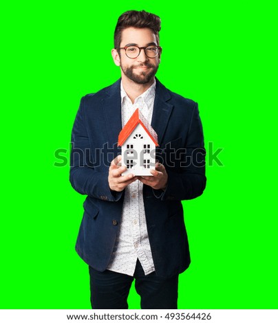 young man holding a house object