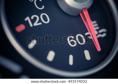 Color close up image of a car's coolant temperature gauge.