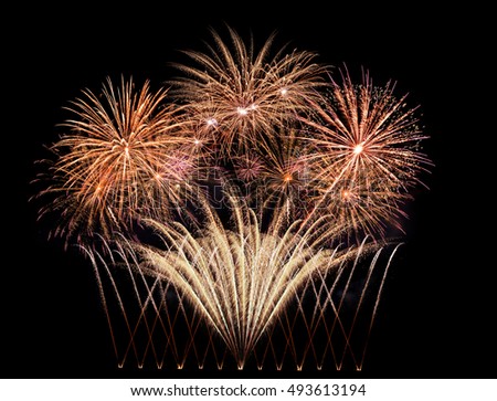 Golden fireworks exploding in the night sky on New Year's Eve
