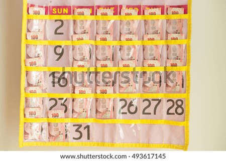 Banknotes in monthly calendar for daily use. Concepts Financial Planning