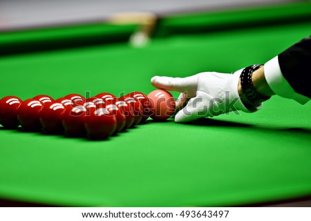 Snooker referee arranging pink ball at the beginning of a game Royalty-Free Stock Photo #493643497