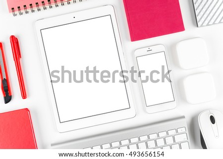 Top view: Keyboard, mouse, tablet computer and smartphone on white table background with space for text and copy space.