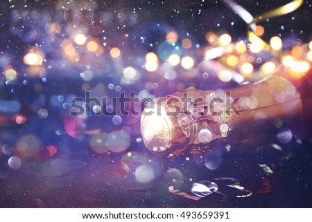 Abstract image of champagne bottle and festive lights. New year and celebration concept