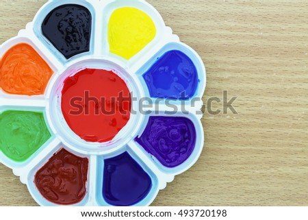 Plastic  palette  with color multi color  on wood background