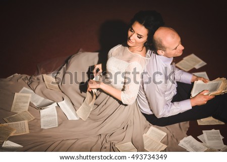 Beautiful luxury newlyweds with book pages