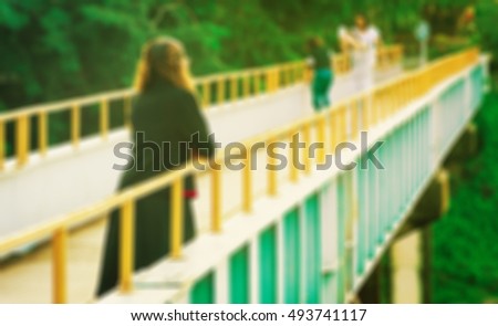 Blur of sad woman on the bridge.
