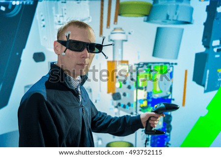 Portrait of engineer with factory graphic in 3D in virtual reality suite
