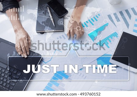 Woman is working with documents, tablet pc and notebook and selecting "Just in time".
