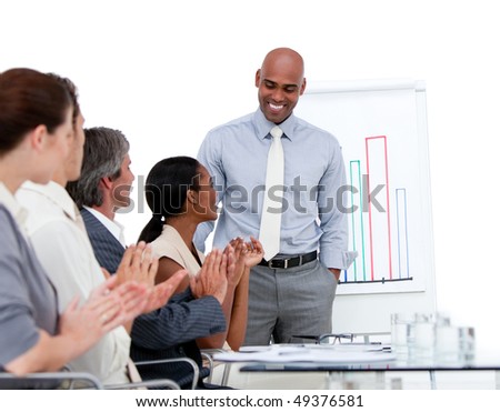 Ethnic businessman presenting statistics in a company against a white background