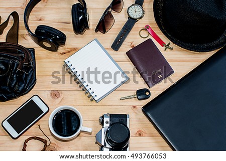 Planning for trip set of travel accessory on wooden background top view,in vintage tone style,copy space,blank,notebook,mobile-phone,camera,map,laptop,bag,glasses,earphone,coffee,passport.