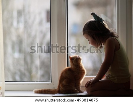 Girl with cat and parrot friends Royalty-Free Stock Photo #493814875
