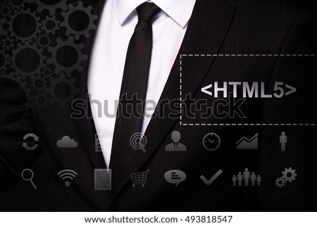Businessman in the suit close. Text "<HTML5>" on the virtual screen badge, on the chest. Business concept. Internet concept.