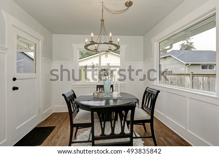 Dining black round table with four cushioned chairs in classic American Dining room. Northwest, USA