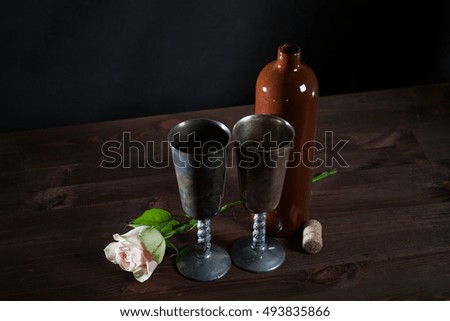 two vintage Cups, a bottle of wine and rose, still life