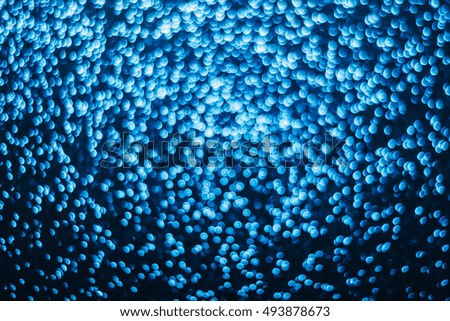 Blue glitter blurry background.