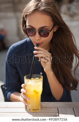 Portrait of a fashionable stylish young woman at outdoors food place.