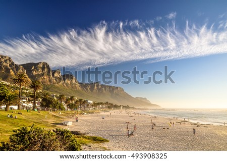 Stunning evening photo of Camps Bay, an affluent suburb of Cape Town, Western Cape, South Africa. With its white beach, Camps Bay attracts a large number of foreign visitors as well as South Africans.