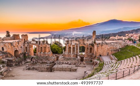 The  Greek Theater of Taormina as the Sun sets behind the smoking Etna, creating the beautiful colors inspiring the Hungarian Csontvary-Kcsztka Tivadar famous 1904-5 painting , Sicily, Catania, Italy Royalty-Free Stock Photo #493997737