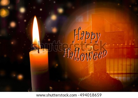 Halloween background, grave in a cemetery and candle