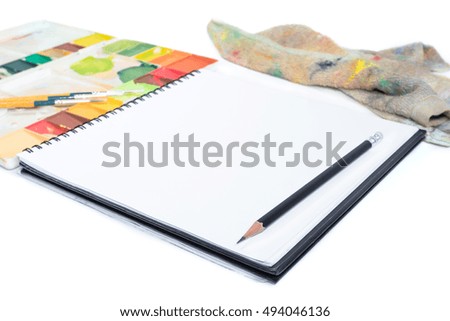 closeup open note book with tray colors on background