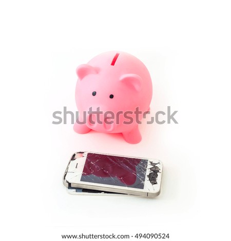 Broken mobile phone with pink piggy bank. Concept photo with meaning to keep saving money for buy new smartphone. Selective focus