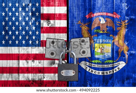 US and Michigan flag on door with padlock