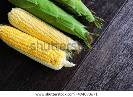 fresh sweet corn on wooden table.Top view shot.