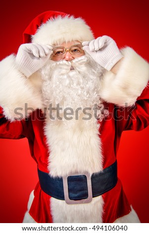 Close-up portrait of a traditional Santa Claus over red background. Studio shot. Christmas.