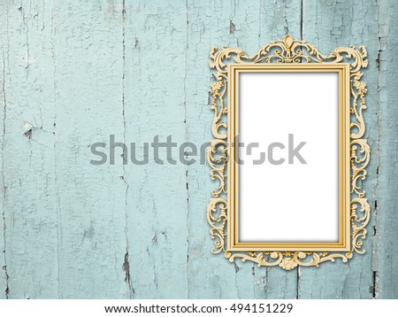 Close-up of one blank golden Baroque picture frame on aqua weathered wooden boards background