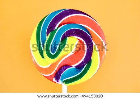 A studio photo of a candy swirl lollypop