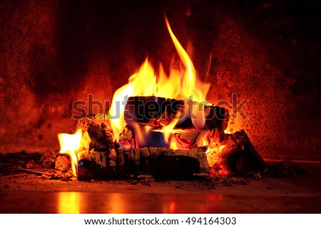 Close up shot of burning firewood in the fireplace. Royalty-Free Stock Photo #494164303
