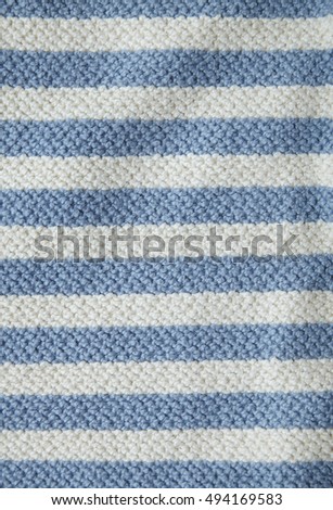 A full page of chunky blue and white striped knitted background texture