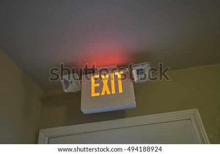 Neon Exit sign above Hotel Doorway