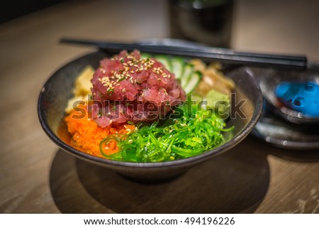 Bowl of Japanese healthy food with raw tuna, seaweed and more over rice. Beautiful traditional Japanese healthy food.