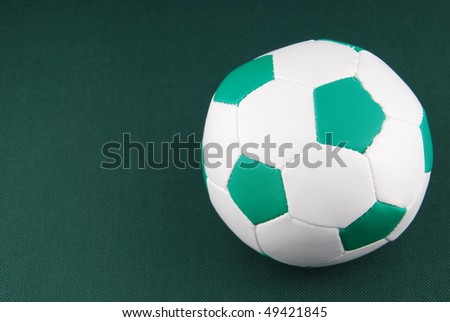 green soft soccer ball for children on green background