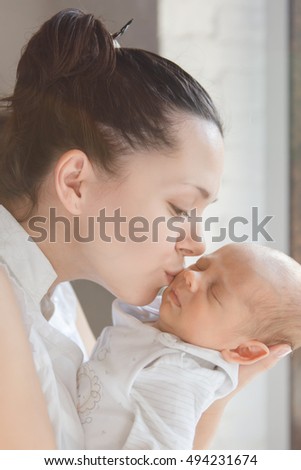 Newborn baby boy in mother's arms