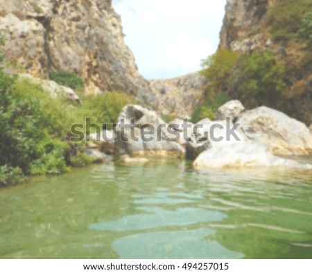 Defocused background of Preveli Lagoon with palms, Crete, Greece. Intentionally blurred post production for bokeh effect.