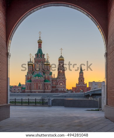 Yoshkar Ola city, Mari El, Russia. The majestic Cathedral with Golden domes inscribed in the arch. The sunset light adds mystery to the photos.
