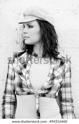 Young woman with style against painted brick wall
