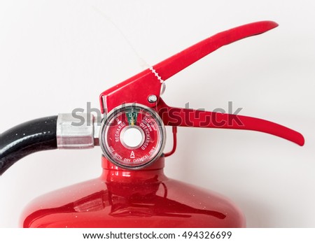 Modern gauge of the fire extinguisher on the white wall.
