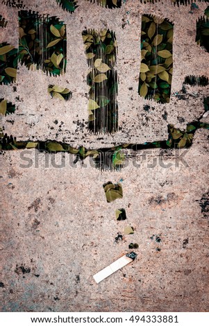 health care and environment concept : cigarette on concrete floor and green leaves background