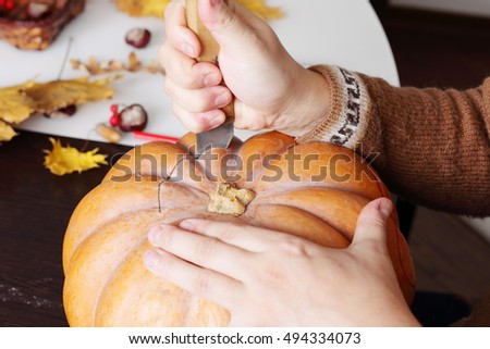 Carving out a pumpkin to prepare halloween lantern