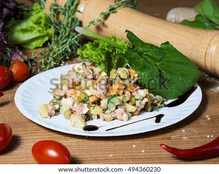 Vegetarian salad and vegetables on a brown wooden background, slose-up
