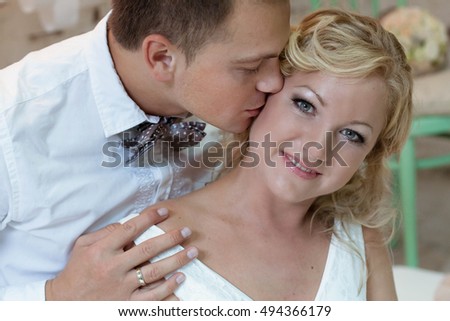 groom kissing her woman on the cheek