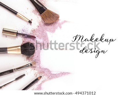 Makeup brushes, lip gloss and pencil on white background, with traces of powder and blush forming a frame. A horizontal template for a makeup artist's business card or flyer design, with copyspace