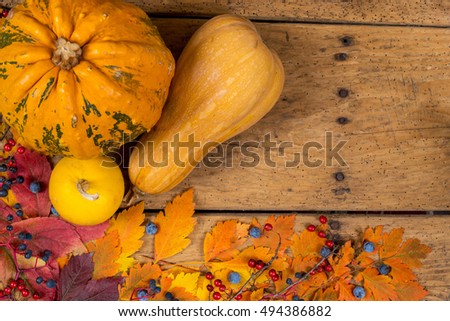 Helloween pumpkins over an old rustic vintage table - top view, copy space