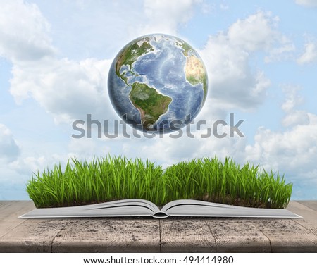 Green landscape covered by grass on an open book on sky background with Globe. Education and environment. Knowledge is power. Elements of this image are furnished by NASA.